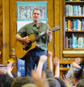 Dave Ruch plays guitar in front of audience